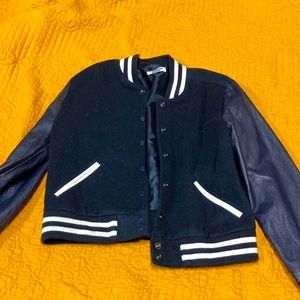 Navy varsity jacket worn like twice